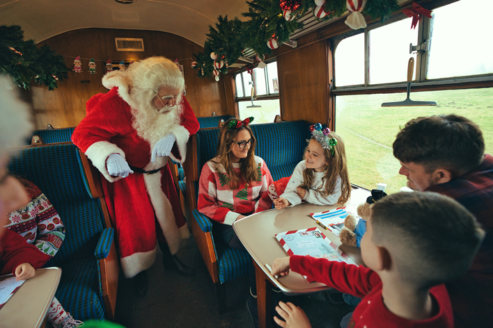 Sant with children on the Strathspey Railways' Elf Express