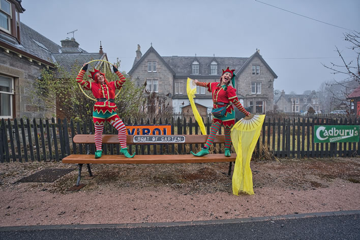 Two eleves dancing on a bench at Boat of Garten station