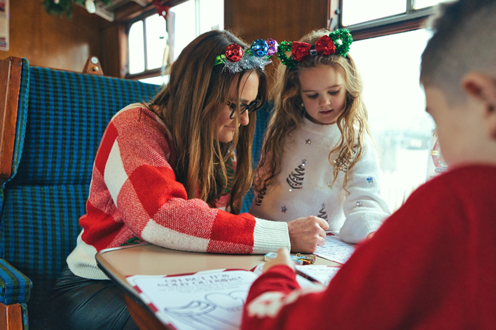 Family enjoy filling in the railways' activity book